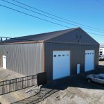A charcoal agriculture and commercial post-frame storage shop with copper penny trims