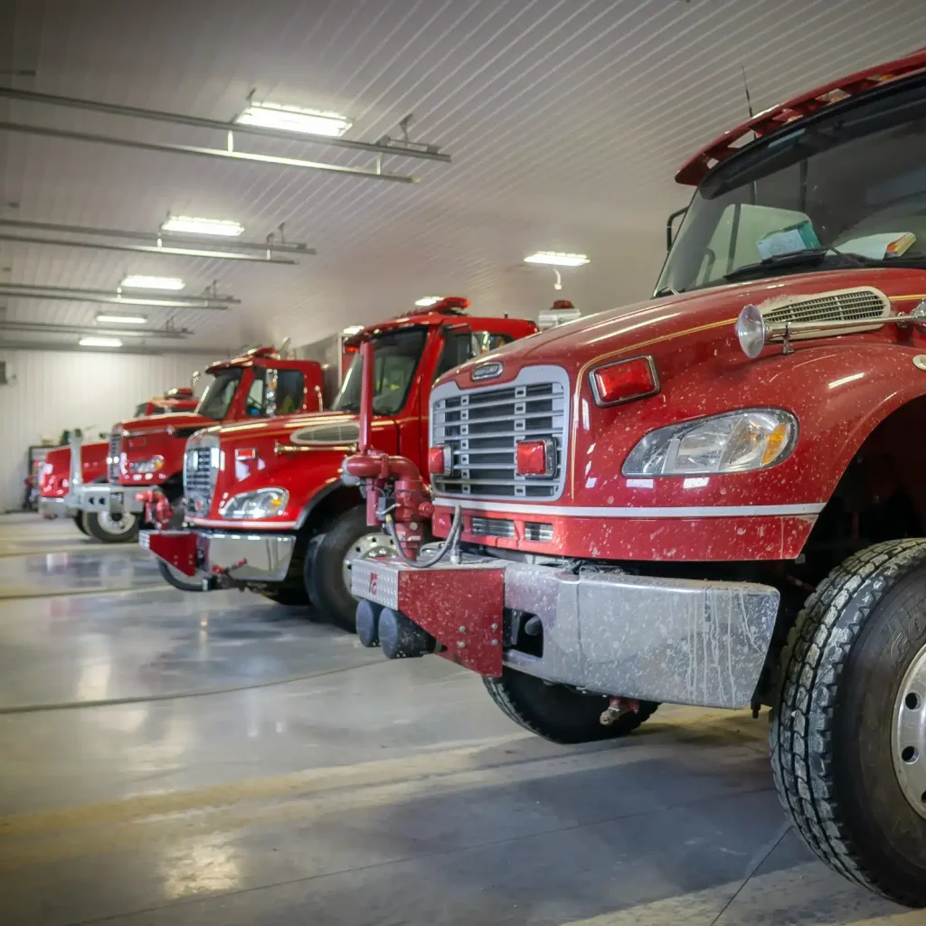 A bright white post-frame commercial building with 10 overhead doors