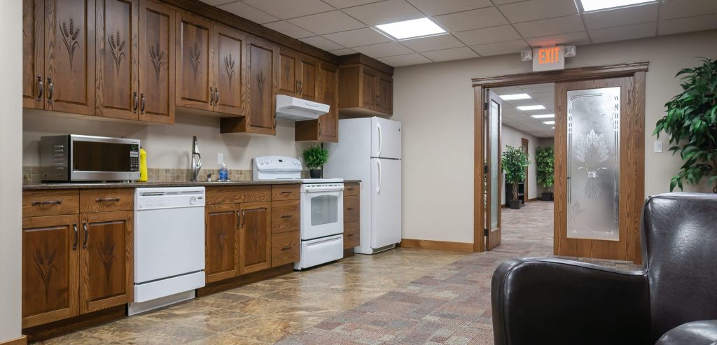 A bright white post-frame commercial building with 10 overhead doors
