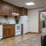 A bright white post-frame commercial building with 10 overhead doors