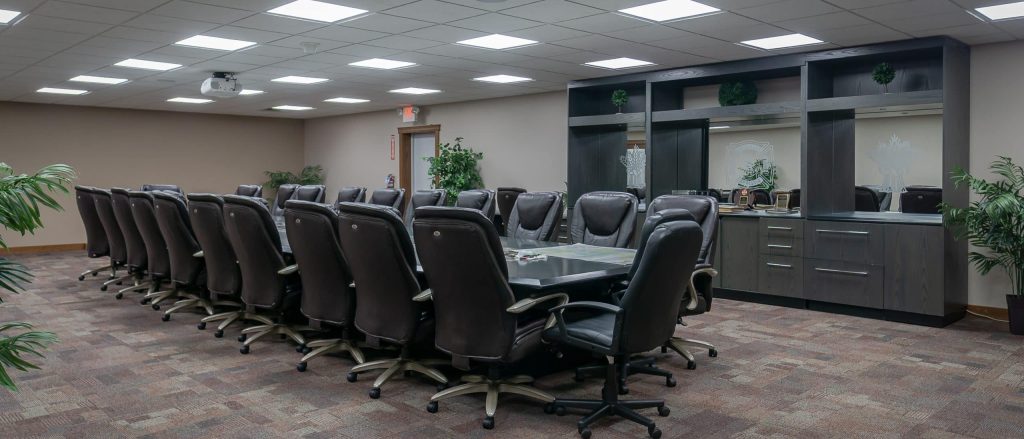 A bright white post-frame commercial building with 10 overhead doors