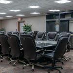 A bright white post-frame commercial building with 10 overhead doors