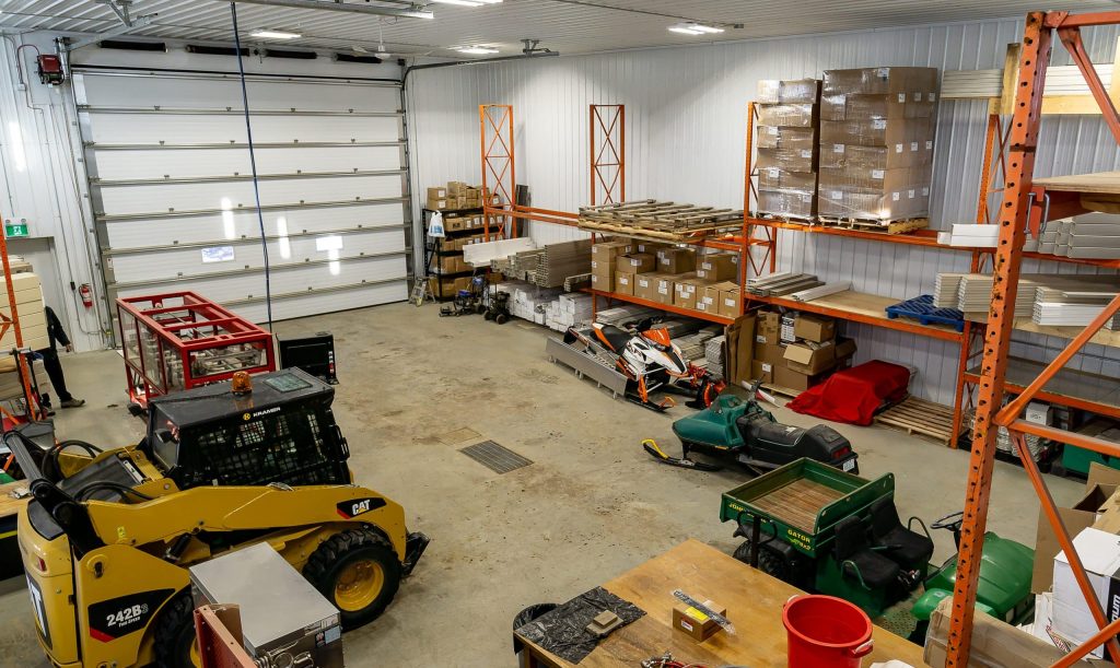 A charcoal post-frame commercial shop with an overhead door