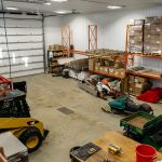 A charcoal post-frame commercial shop with an overhead door