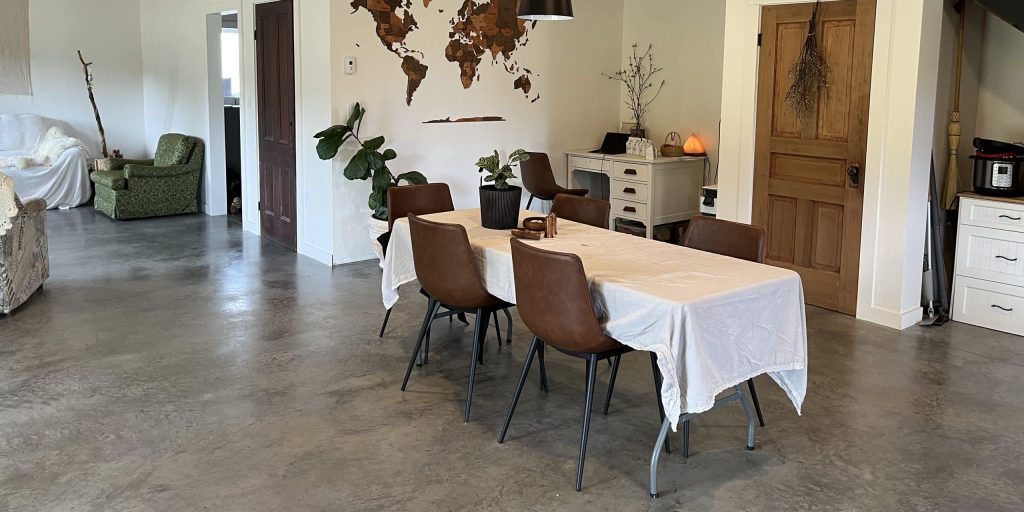 A bright white post-frame Residential Shouse with soffits and an overhead door
