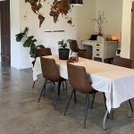 A bright white post-frame Residential Shouse with soffits and an overhead door