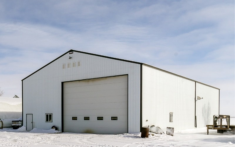 A bright white post-frame agriculture shop/storage building