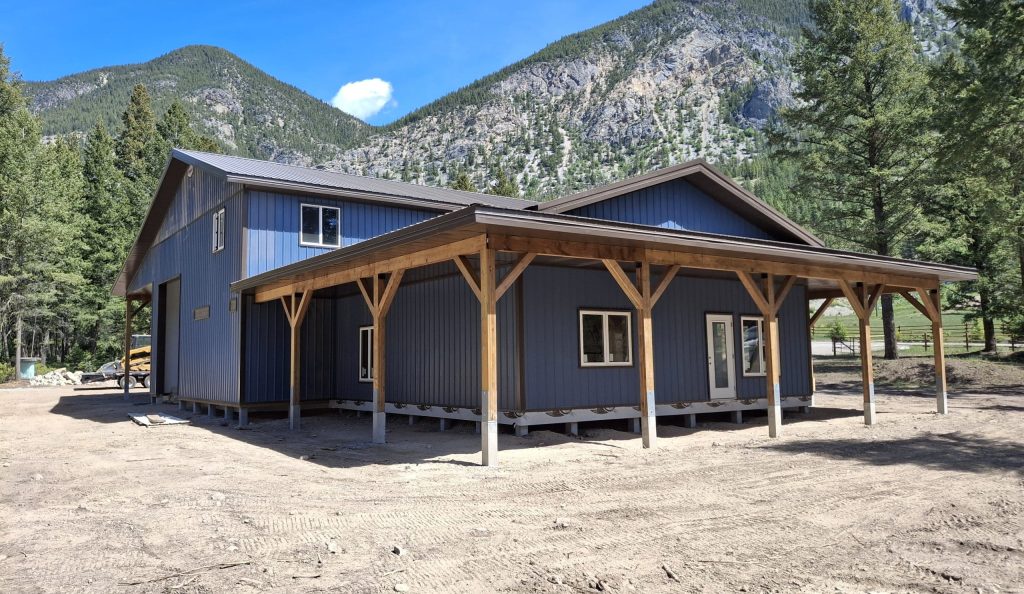 A bluebird post-frame custom residential suite with a garage and open lean-to