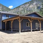 A bluebird post-frame custom residential suite with a garage and open lean-to
