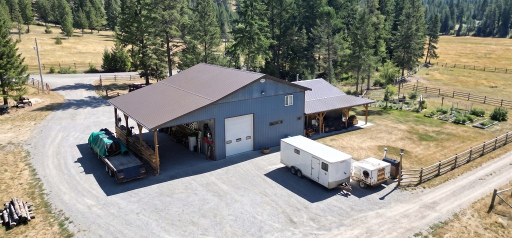 A bluebird post-frame custom residential suite with a garage and open lean-to