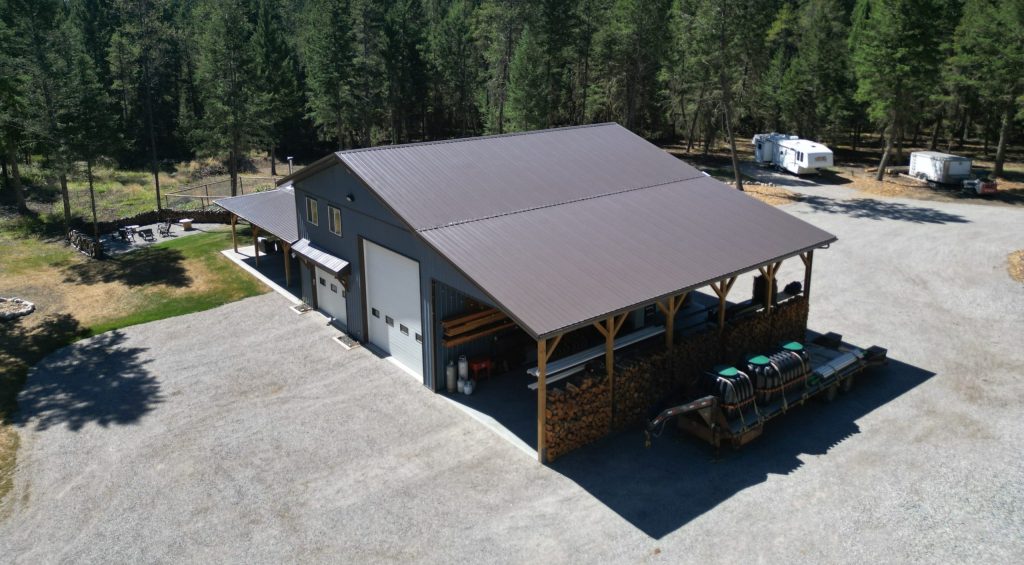 A bluebird post-frame custom residential suite with a garage and open lean-to