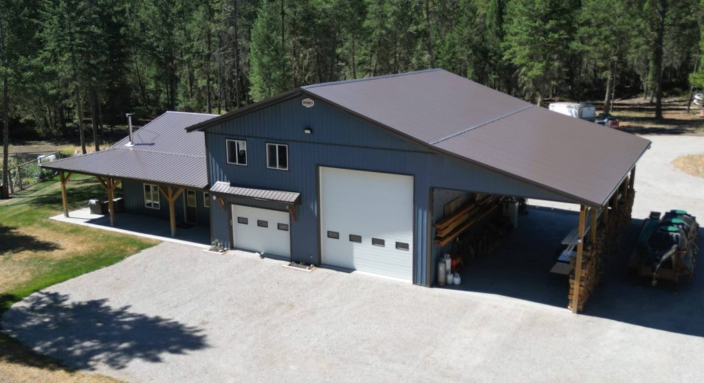 A bluebird post-frame custom residential suite with a garage and open lean-to