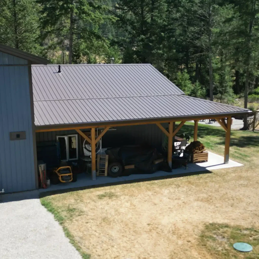 A bluebird post-frame custom residential suite with a garage and open lean-to