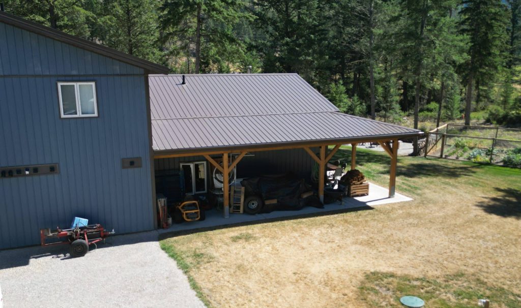 A bluebird post-frame custom residential suite with a garage and open lean-to