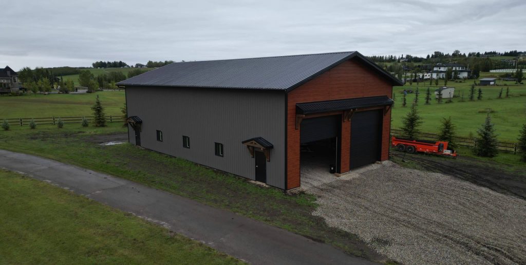A post-frame commercial storage building with premium Frontier metal cladding and black overhead doors