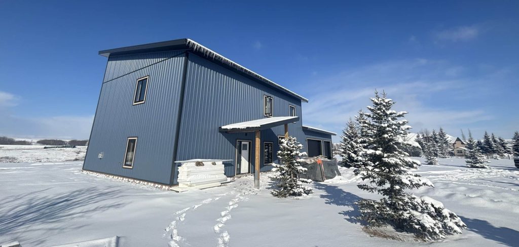 A blue bird post-frame prairie Peak residential home