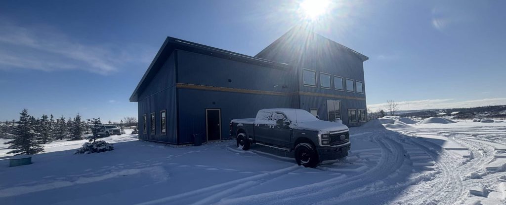 A blue bird post-frame prairie Peak residential home