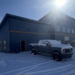 A blue bird post-frame prairie Peak residential home