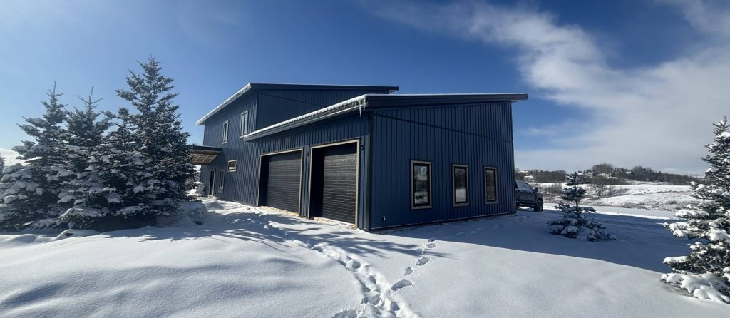A blue bird post-frame prairie Peak residential home