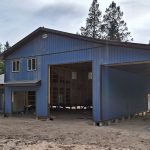 A bluebird post-frame custom residential suite with a garage and open lean-to