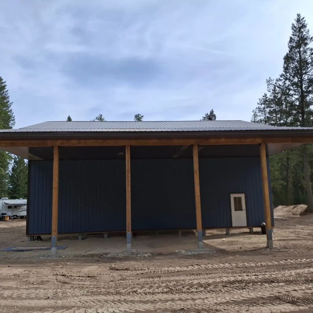 A bluebird post-frame custom residential suite with a garage and open lean-to