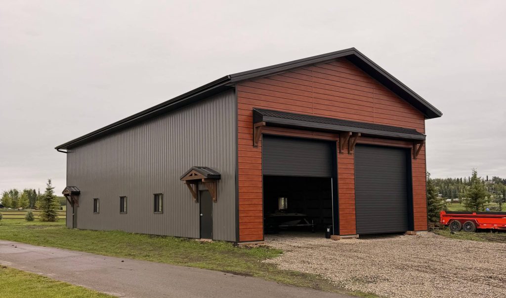 A post-frame commercial storage building with premium Frontier metal cladding and black overhead doors
