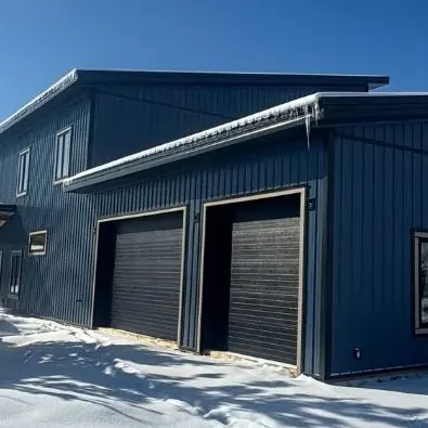 A blue bird post-frame prairie Peak residential home