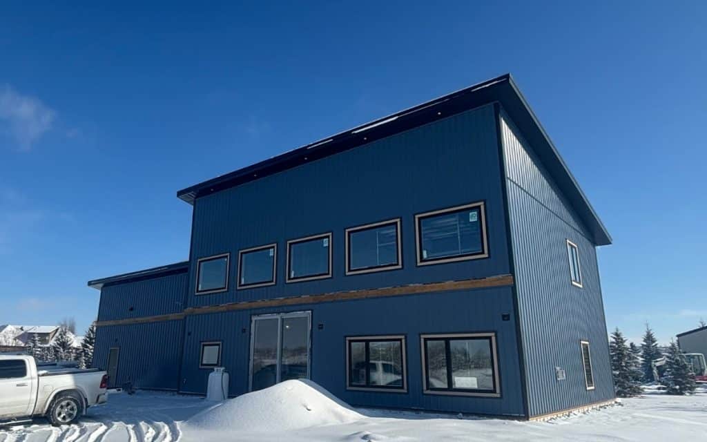 A blue bird post-frame prairie Peak residential home