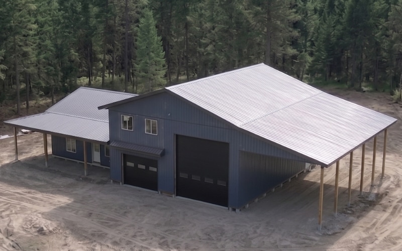 A bluebird post-frame custom residential suite with a garage and open lean-to