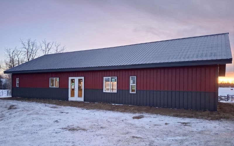 A dark red Bunk House with dark red walls and Iron Ore wainscoting