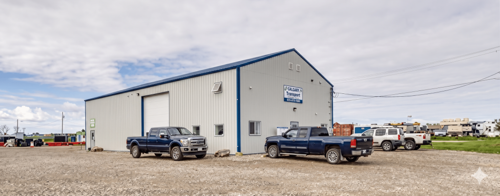 A bone white post-frame commercial shop with heron blue exterior trims