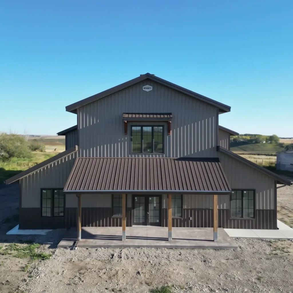 A post-frame residential barndominium with buckskin walls and coffee brown wainscoting