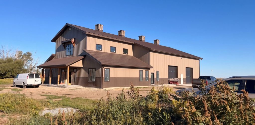 A post-frame residential barndominium with buckskin walls and coffee brown wainscoting