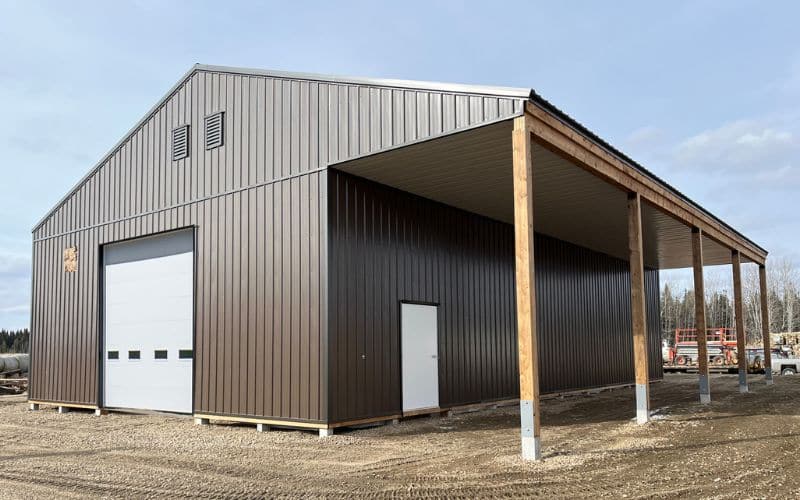 A coffee brown post-frame agriculture barn with overhead door