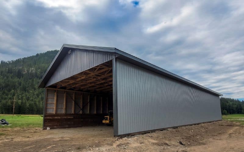 A Regent Grey post-frame hay shed with gunmetal roof and soffits