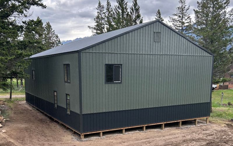 A Dark sage post-frame agriculture shop with Iron Ore wainscoting
