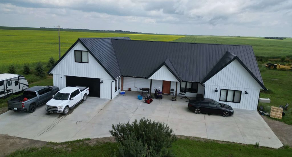 Explore the custom Homestead with loft built for Tyler near Kindersley, SK. Features upgraded Board and Batten Bright White siding and a functional, high-capacity design.
