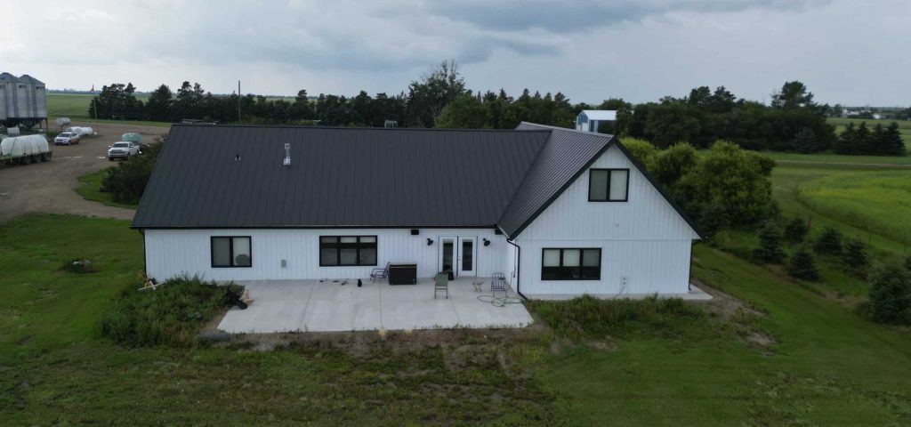 Explore the custom Homestead with loft built for Tyler near Kindersley, SK. Features upgraded Board and Batten Bright White siding and a functional, high-capacity design.