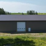 A Buckskin post-frame agriculture building with a bi-fold and overhead doors