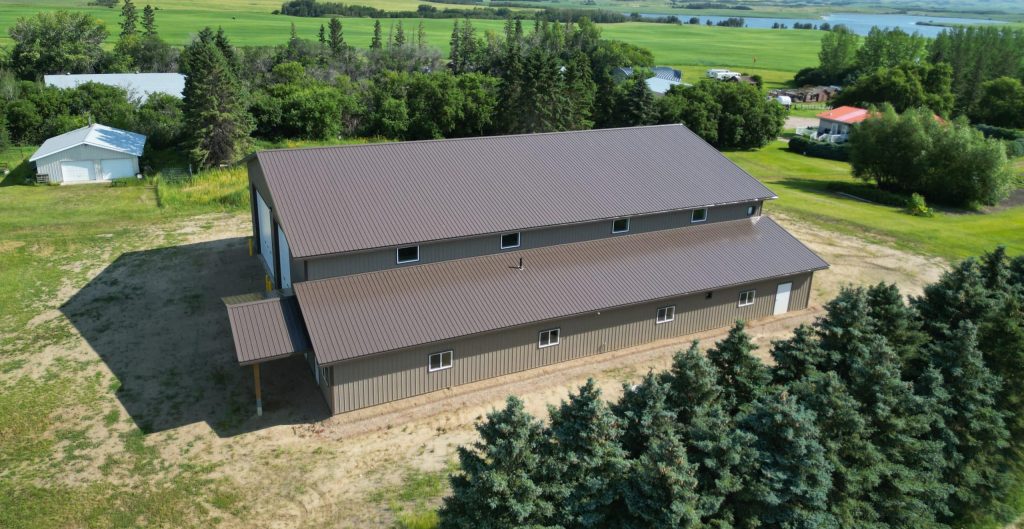 A Buckskin post-frame agriculture building with a bi-fold and overhead doors