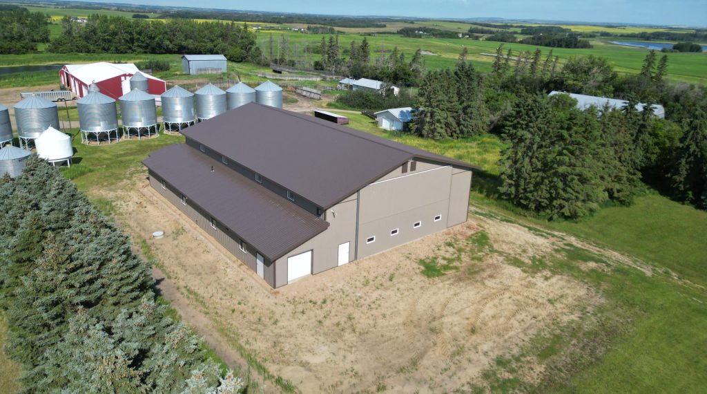 A Buckskin post-frame agriculture building with a bi-fold and overhead doors