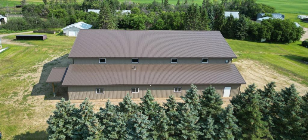 A Buckskin post-frame agriculture building with a bi-fold and overhead doors