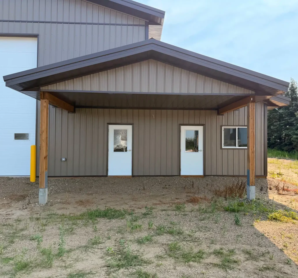 A Buckskin post-frame agriculture building with a bi-fold and overhead doors