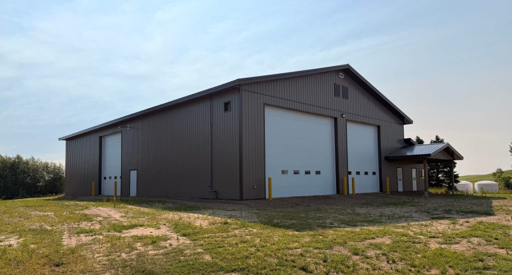 A Buckskin post-frame agriculture building with a bi-fold and overhead doors