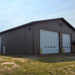 A Buckskin post-frame agriculture building with a bi-fold and overhead doors
