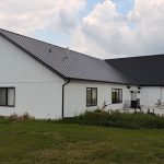 Explore the custom Homestead with loft built for Tyler near Kindersley, SK. Features upgraded Board and Batten Bright White siding and a functional, high-capacity design.