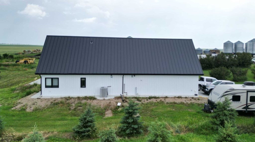 Explore the custom Homestead with loft built for Tyler near Kindersley, SK. Features upgraded Board and Batten Bright White siding and a functional, high-capacity design.