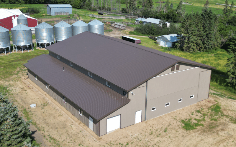 A Buckskin post-frame agriculture building with a bi-fold and overhead doors