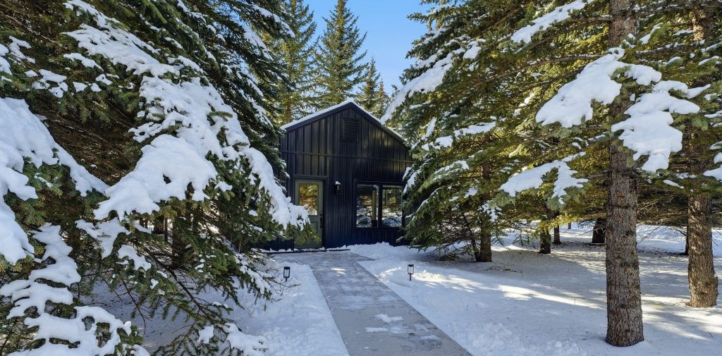 A black post-frame guest house