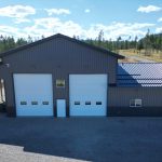 A charcoal post-frame agriculture storage building with wainscoting and overhead doors